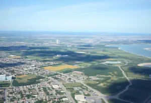 Aerial view of Virginia Beach cityscape with green spaces and farmland